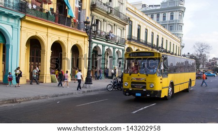 HAVANA - JANUARY 11: An old (Dutch) bus and antique buildings on January 11, 2013 in Havana, Cuba. Trade agreements between Castro and investors resulted in the import of foreign buses into Cuba