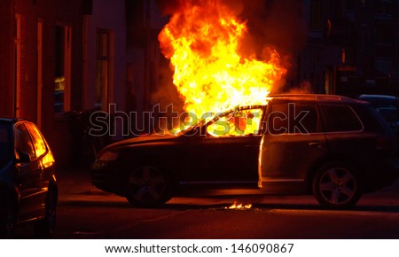 A burning car in a street