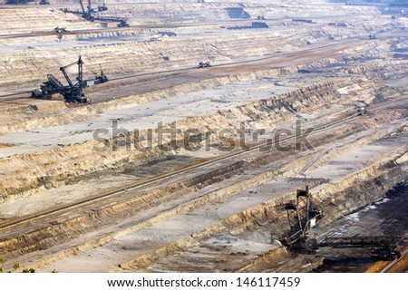 Large bucket wheel excavators digging brown-coal in an open-pit mine
