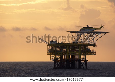 A helicopter on top of a offshore oil-platform for transporting roughnecks to nearby rigs