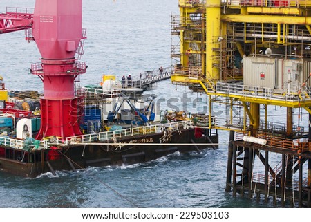 SOUTH CHINA SEA, BRUNEI - JANUARY 26: A crane of Ampelmann  on deck of a vessel on January 26, 2014 in Brunei. This system allows a safe access to offshore structures, even in high wave conditions