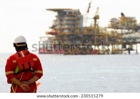 Rig workers and an oil platform