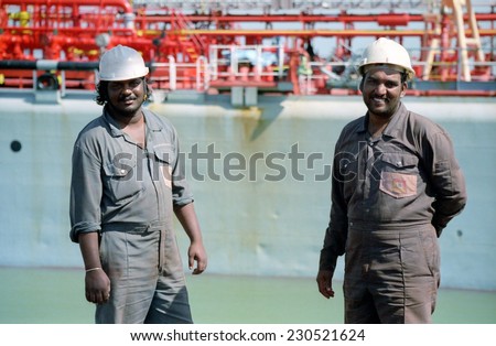 KAKINADA, INDIA - JANUARY 30, 2013: Harbor workers in the port of Kakinada, India on January 30th , 2013. The port increased in commercial activity due to India\'s significant economic growth