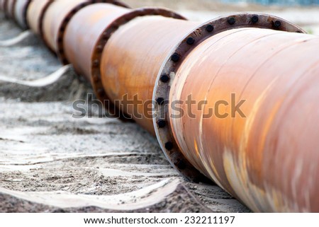 Corroded pipeline, used for land reclamation, on a beach. Holland