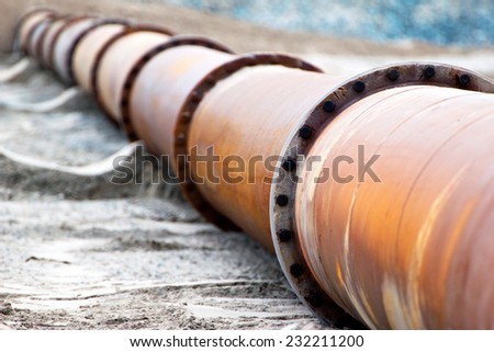 Corroded pipeline, used for land reclamation, on a beach. Holland