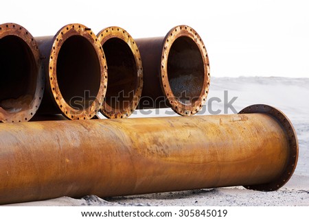 Corroded pipelines, used for land reclamation, on a beach, Holland