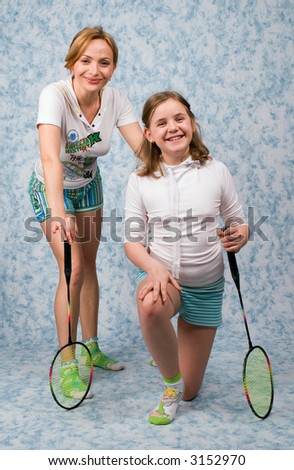Mum and daughter play badminton on a blue background