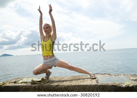 The young woman is engaged in gymnastics on sea