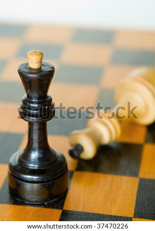 Combination from chessmen on an old board. Focus on black king.