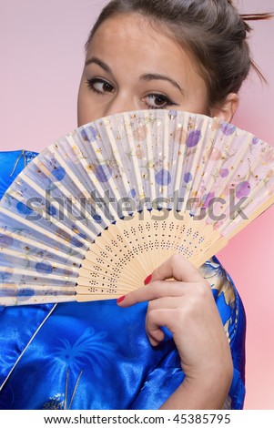 Portrait of the girl in national clothes and with a fan