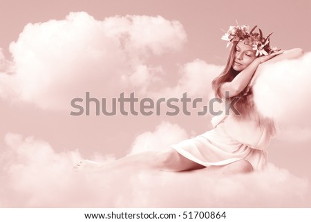 The beautiful girl in a suit of spring sleeps on clouds