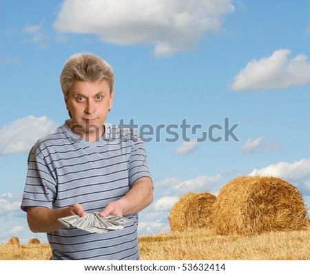 The man with a pack of money on background landscape