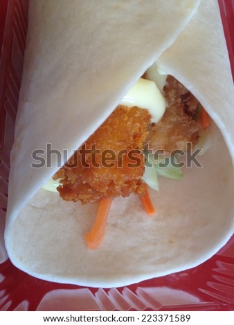 chicken with salad and salsa wrapped in a soft flour tortilla.