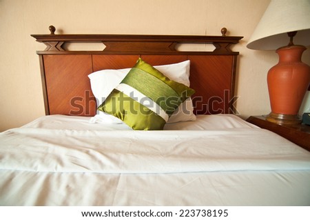 Room setting with bed and  silk pillows
