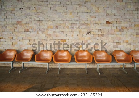 Empty Plastic Chairs on stone background