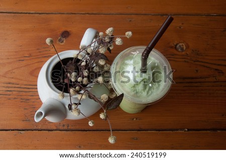 Milk Green tea smoothie in plastic cup on wood table