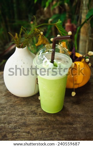 Green tea smoothies on wooden table