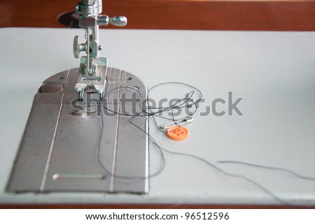 Close-up of needle and thread on sewing machine.
