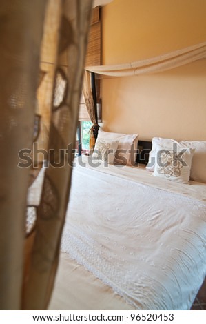 Curtain-covered  bedroom wooden at resort