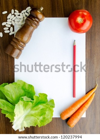 Blank white paper and fresh colorful vegetables on  kitchen table