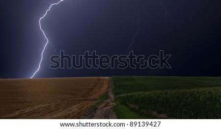 Lightning strikes between a field of wheat and corn