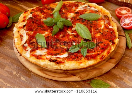 Baked pizza with tomatoes and zucchini