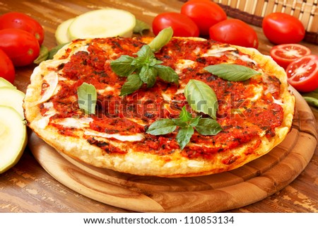 Baked pizza with tomatoes and zucchini