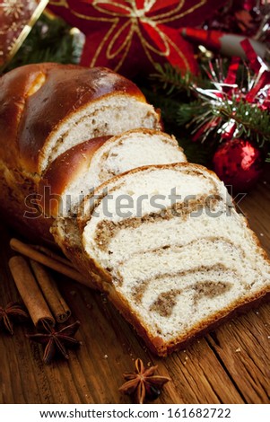 Sweet bread with nuts and spices on Christmas decoration background