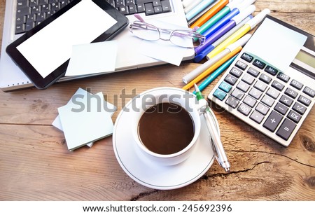 Coffee Cup at Office with Tablet and Laptop, Electronic Computer , Glasses and Pencils on Wooden Desk