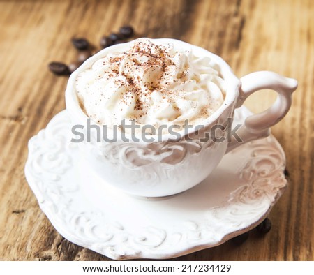 Vintage Coffee Cup with Cappuccino and Whipped Cream on Wooden Background