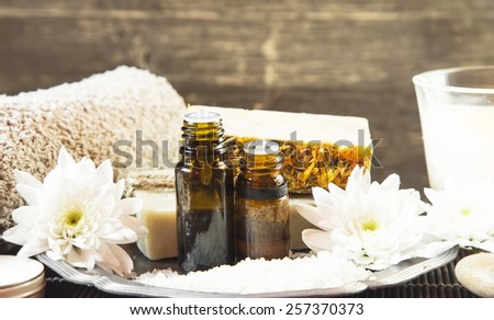 Natural Spa Setting and Treatment with Essential Oils and Cotton Towels, Natural Soap and White Flowers