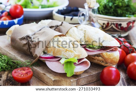 Tasty Ciabatta Sandwiches with Italian Mortadella, Green Lettuce and Radish Slices