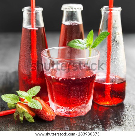 Refreshing Red Juice with Strawberries and Mint in Transparent Bottles and Glass with Straws