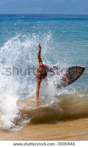 Young male Surfer catching air off a wave