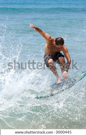 Male surfer catching air off a wave