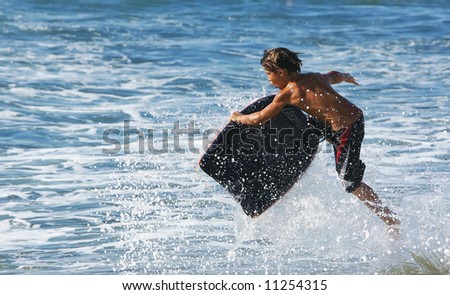 Young child in the air on his boogie board