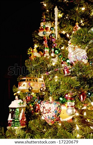 Colorful Christmas tree full of ornaments, focus on the foreground, blurred background