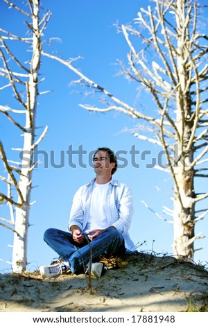Meditating Man on a Hillside