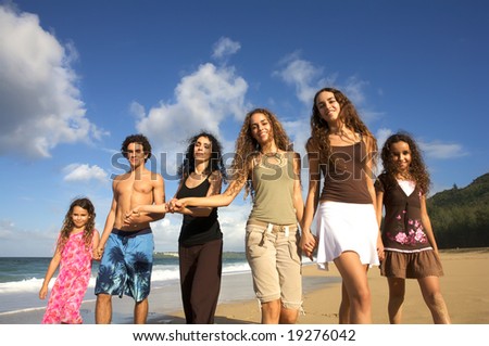 Children Holding Hands On The Beach. Mom holding hands with her