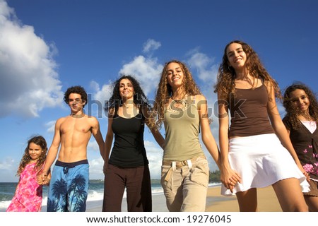 Children Holding Hands On The Beach. Mom holding hands with her