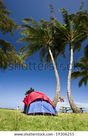Bright Blue and red tent with clothes hanging to  dry in Kauai, Hawaii