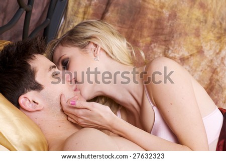 Beautiful Young Couple in Love in Bed Together