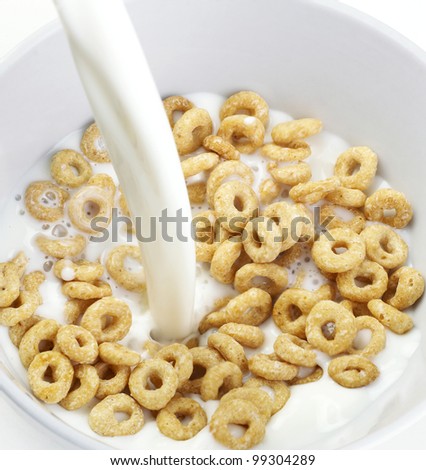 Cereal Bowl With Milk Pouring isolated on white