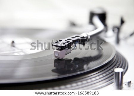 Record Player with a Vinyl for a Dj for Entertainment. The turntable is turning a vinyl with music sound.