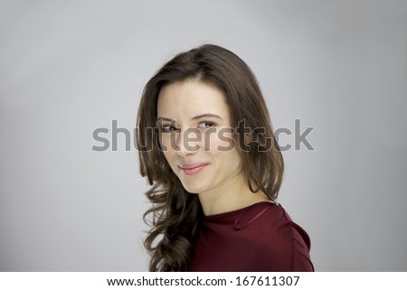 Young female Model with long brown hair and a modern haircut. A very beautiful woman with an ideal make up.