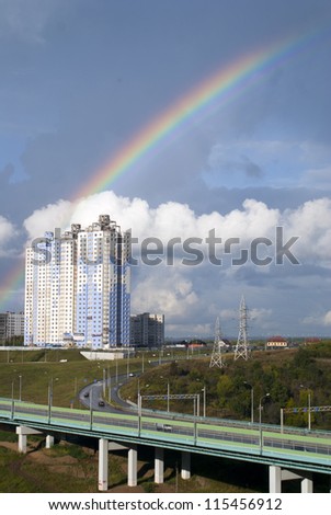 Urban panorama with rainbow