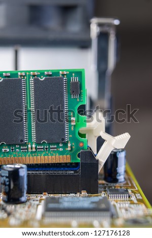Memory module in a PC is being removed from the slot on the mother board.