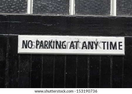 No Parking on a black painted garage door