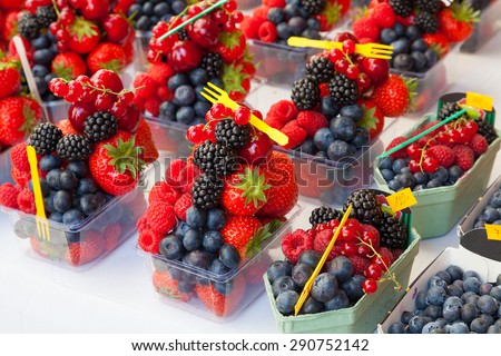Display of mixed fresh fruit berries in containers ready to eat.