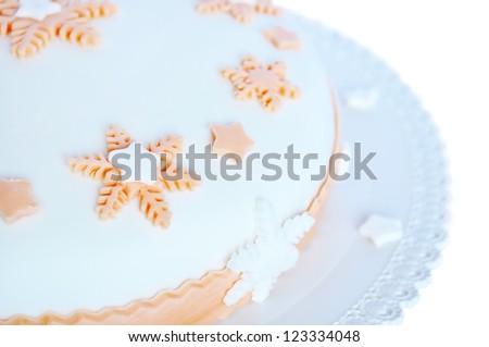 Sugar paste, white cake with pink decoration in the shape of stars and snowflakes. Isolated on white background